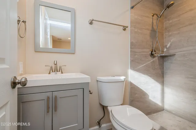 a bathroom with a sink mirror vanity and toilet