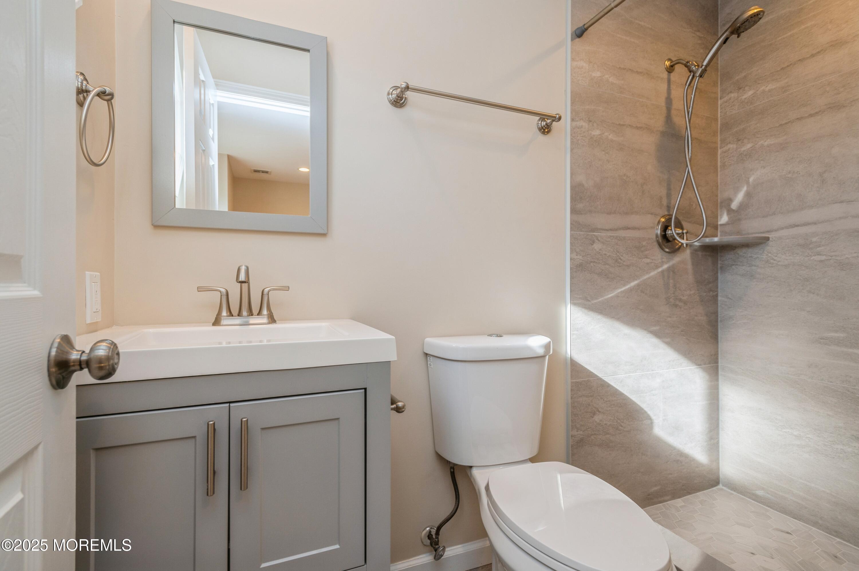 59 Harbor Inn Road Bayville, NJ 08721 - Photo 11 of 25 a bathroom with a sink mirror vanity and toilet