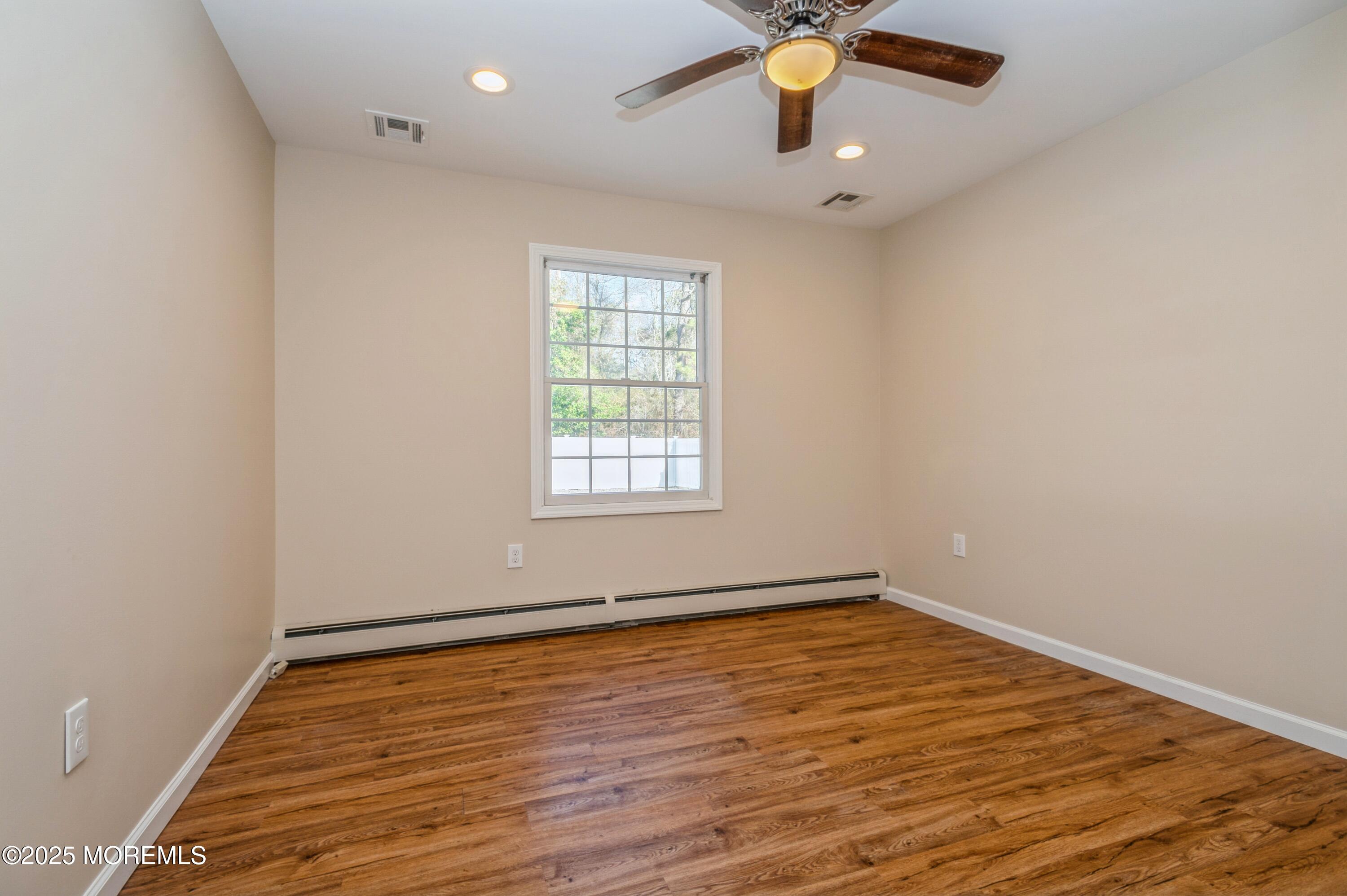 59 Harbor Inn Road Bayville, NJ 08721 - Photo 16 of 25 wooden floor in an empty room with a window