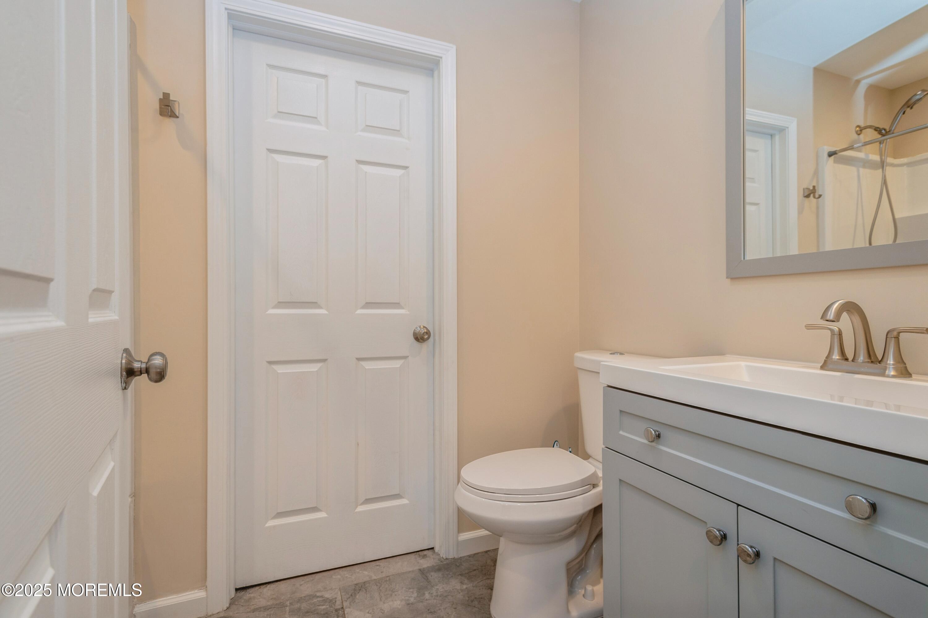 59 Harbor Inn Road Bayville, NJ 08721 - Photo 18 of 25 a bathroom with a toilet a sink a vanity and mirror