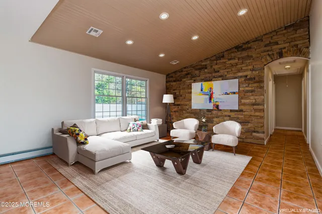 a living room with furniture rug and window