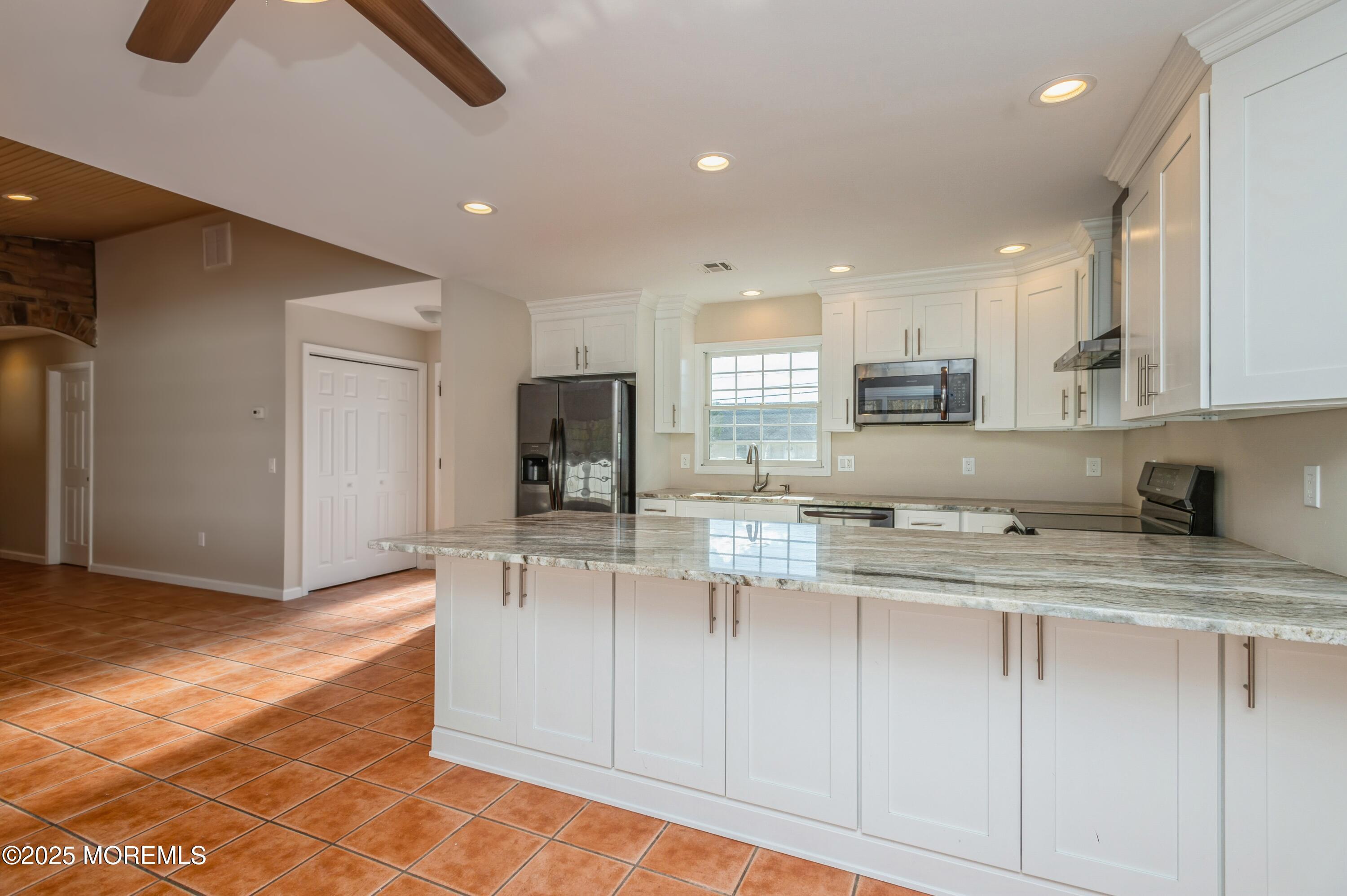 59 Harbor Inn Road Bayville, NJ 08721 - Photo 6 of 25 a kitchen with kitchen island granite countertop appliances cabinets and a sink