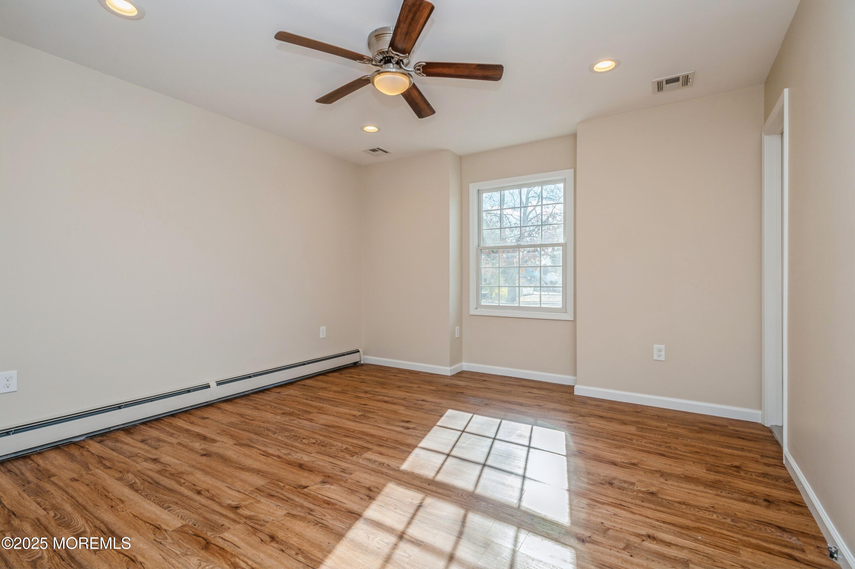 59 Harbor Inn Road Bayville, NJ 08721 - Photo 9 of 25 wooden floor in an empty room with a window