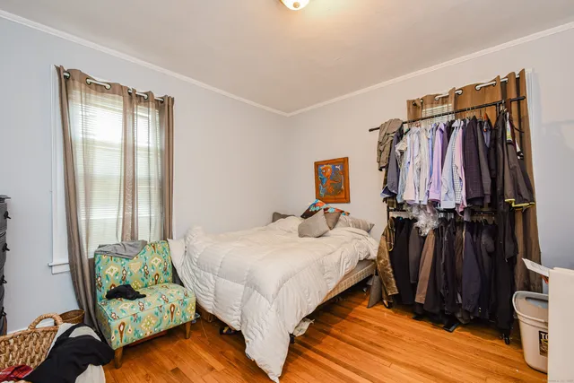 a bedroom with a bed and a mirror