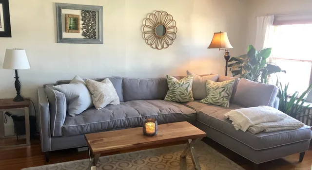 a living room with furniture and a lamp