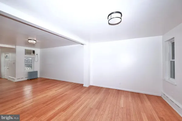 a view of room with window and wooden floor
