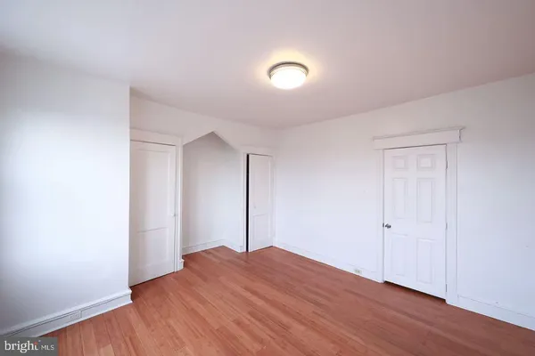 an empty room with wooden floor