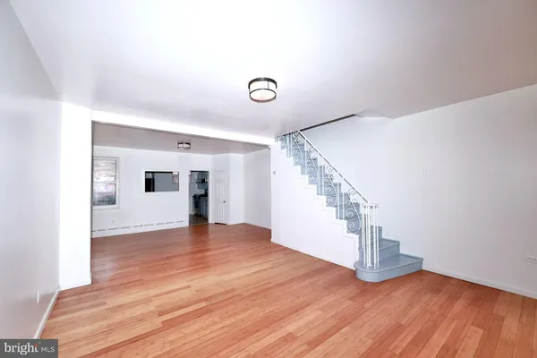 a view of empty room with wooden floor