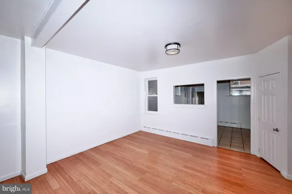 a view of empty room with wooden floor