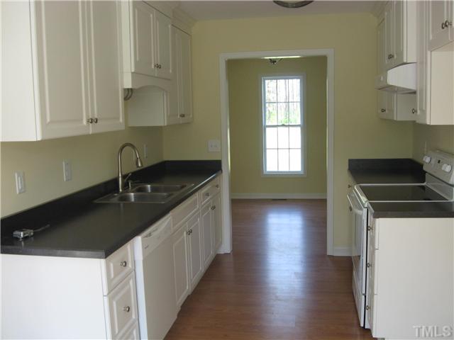 880 Revell Road Selma, NC 27576 - Photo 4 of 7 New custom cabinets, new smooth top stove, dishwasher, sink, fixtures, floor and light fixtures.