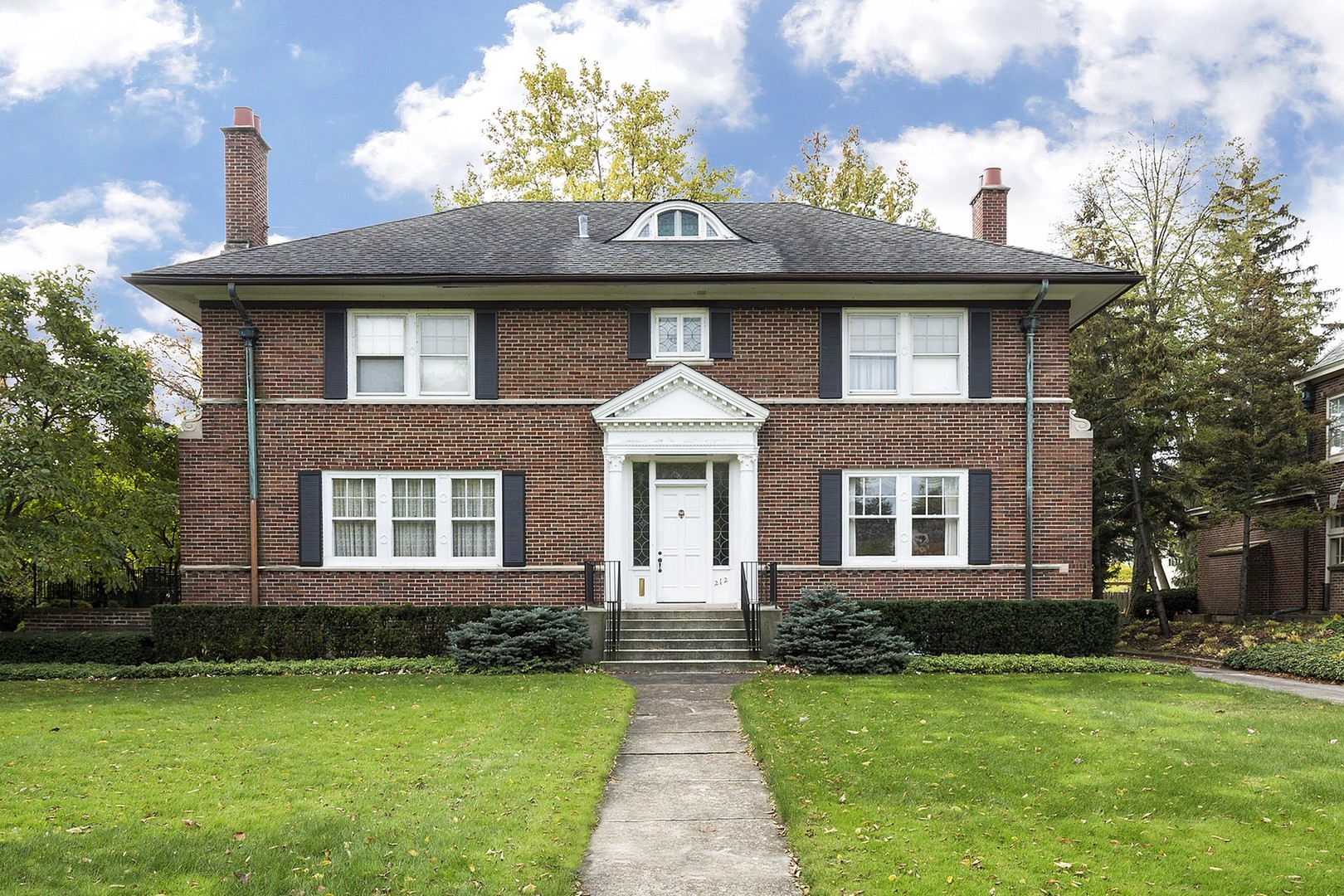 212 Raleigh Road Kenilworth, IL 60043 - Photo 1 of 26 a front view of a house with garden