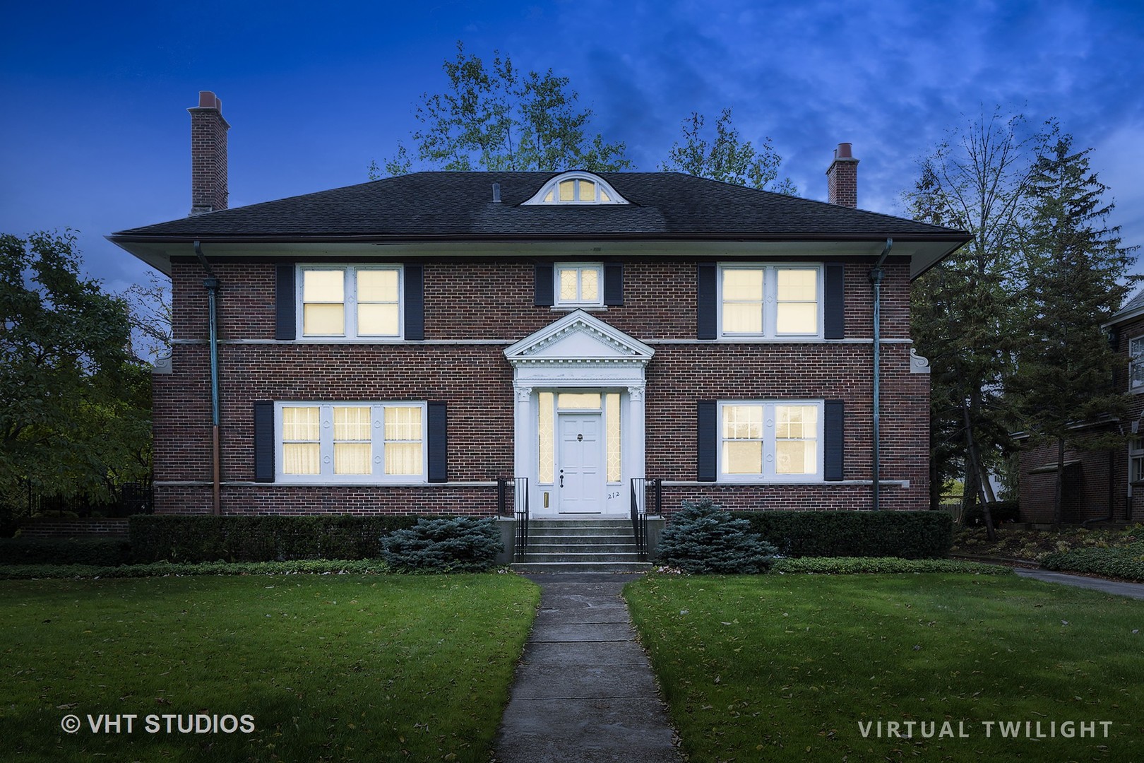 212 Raleigh Road Kenilworth, IL 60043 - Photo 2 of 26 a front view of a house with a yard