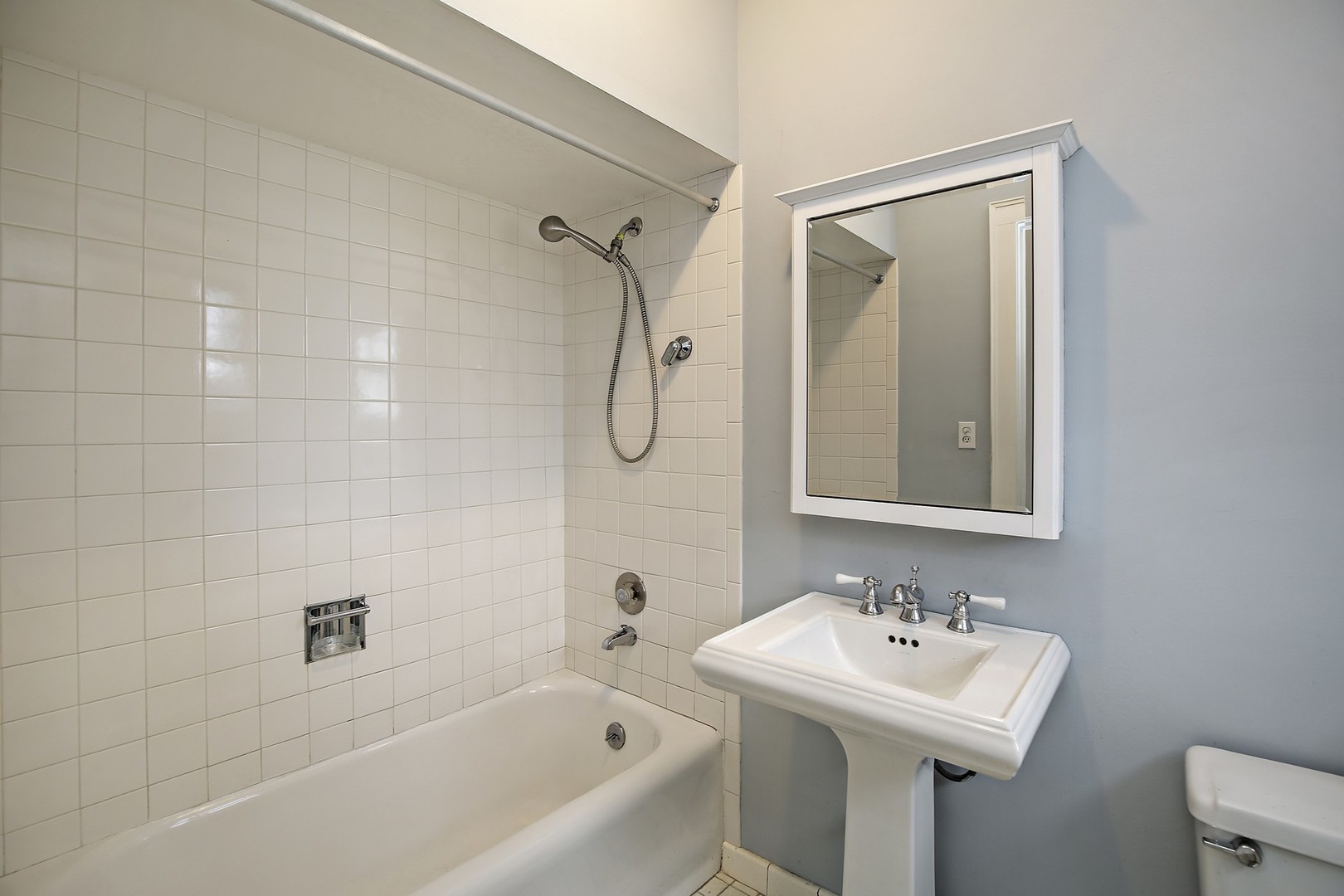 212 Raleigh Road Kenilworth, IL 60043 - Photo 13 of 26 a bathroom with a sink a toilet and shower