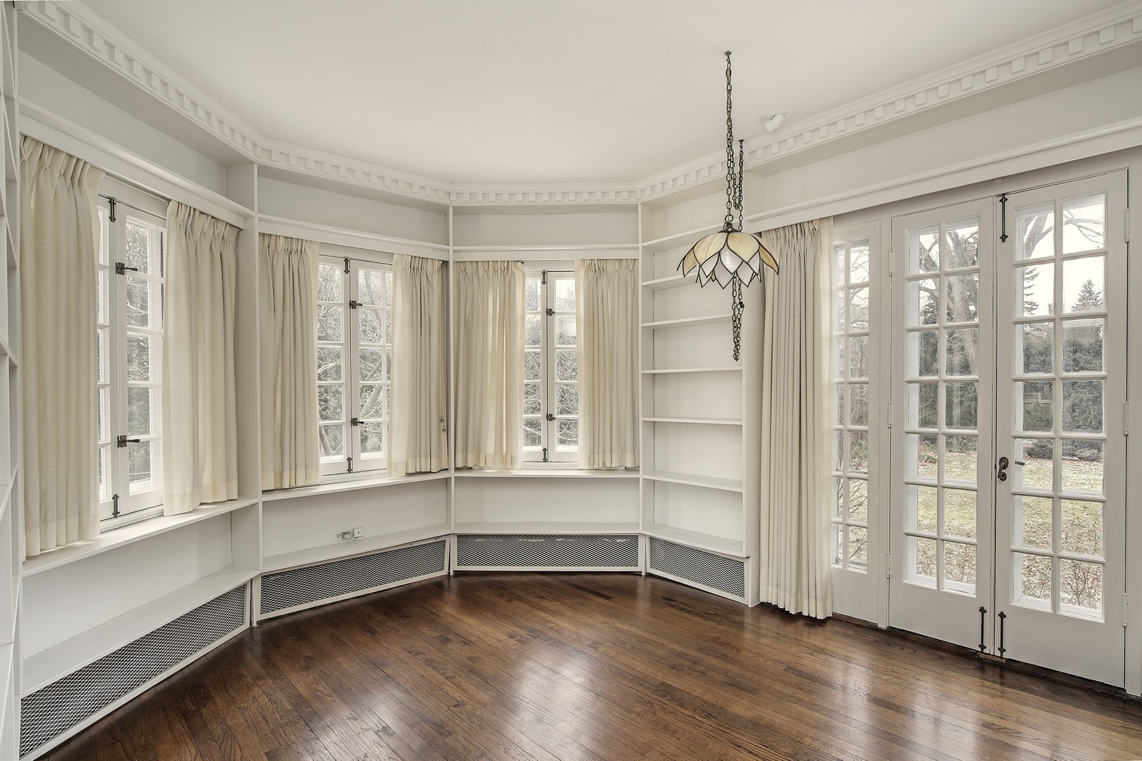 212 Raleigh Road Kenilworth, IL 60043 - Photo 14 of 26 a view of an empty room with a window and wooden floor
