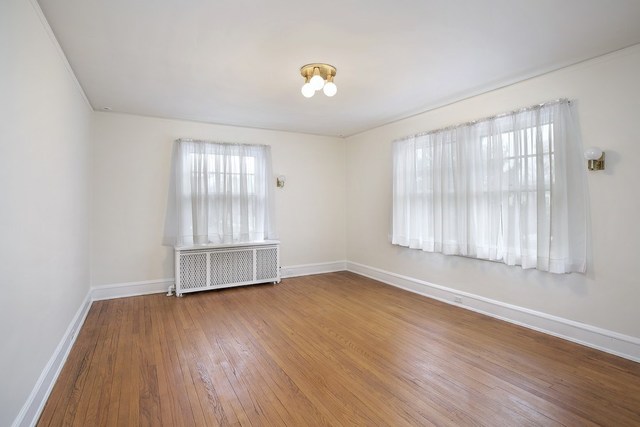 212 Raleigh Road Kenilworth, IL 60043 - Photo 23 of 26 an empty room with wooden floor and windows