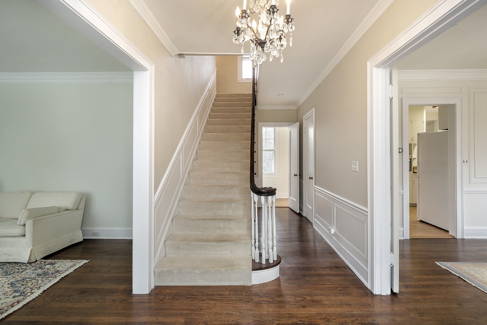 212 Raleigh Road Kenilworth, IL 60043 - Photo 6 of 26 a view of a hallway with wooden floor and staircase