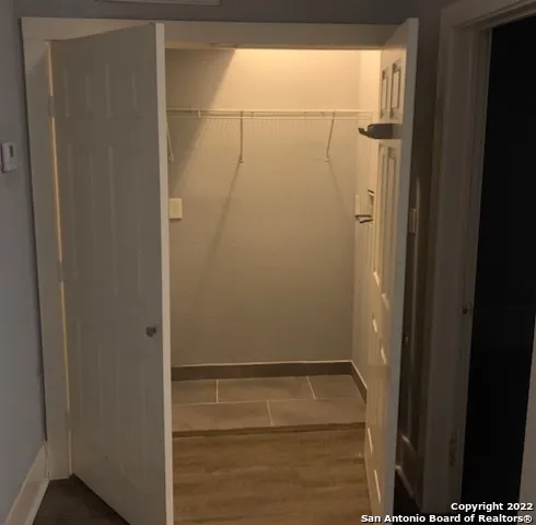 a bathroom with a toilet sink vanity and shower