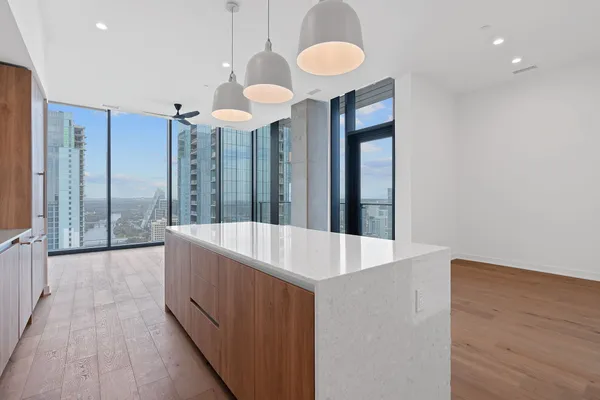 a large white kitchen with a large window