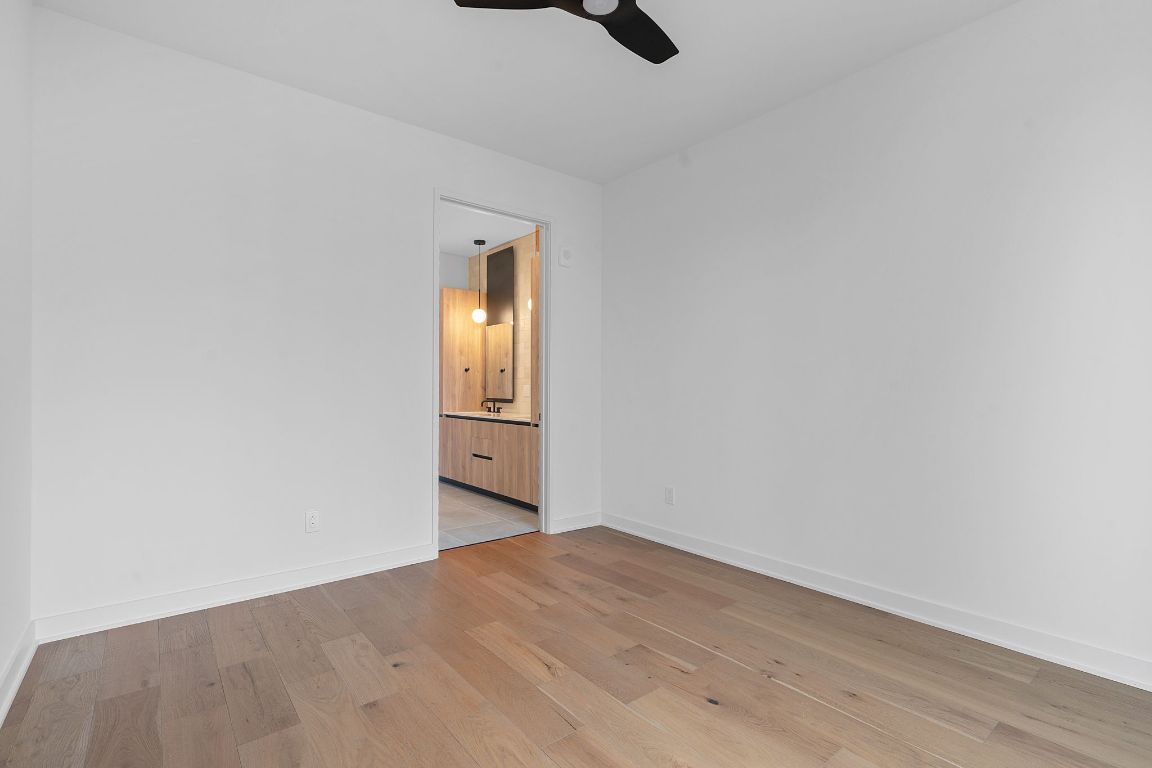 84 East Avenue, Unit 4001 Austin, TX 78701 - Photo 11 of 40 Unfurnished room with light wood finished floors and a ceiling fan