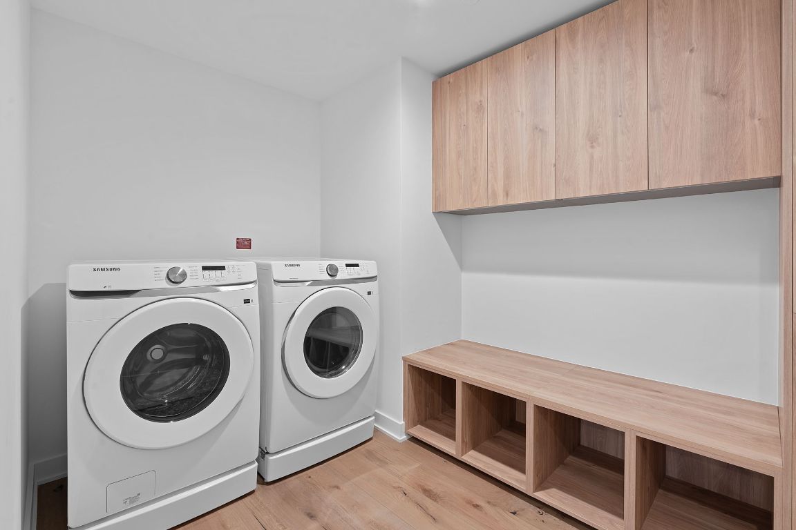 84 East Avenue, Unit 4001 Austin, TX 78701 - Photo 20 of 40 Laundry room featuring washing machine and dryer and light wood-style floors