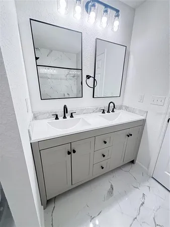 a bathroom with a double vanity sink and mirror