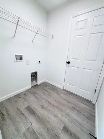 a view of a room with wooden floor