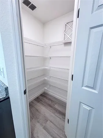a refrigerator freezer and a wooden floor