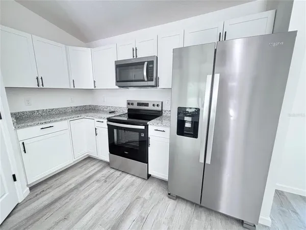 a kitchen with a refrigerator sink and microwave