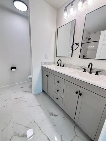 a bathroom with a double vanity sink and mirror