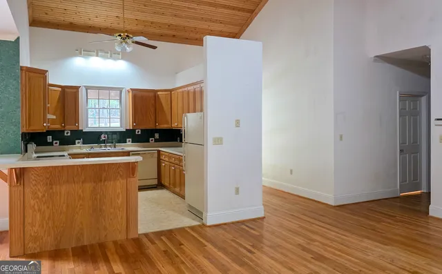 a kitchen with wooden floors and wooden cabinets