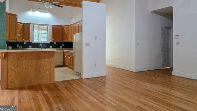 a view of a kitchen from a hallway