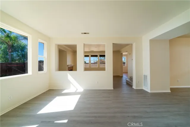 a view of a living room hardwood and furniture
