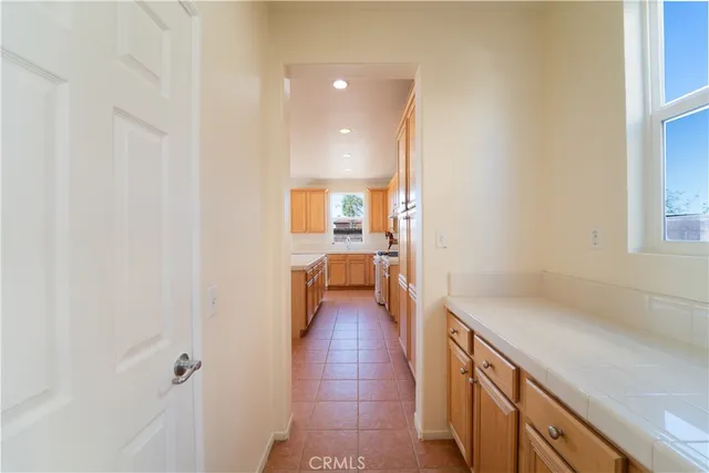 a view of a hallway with wooden floor and a bathroom