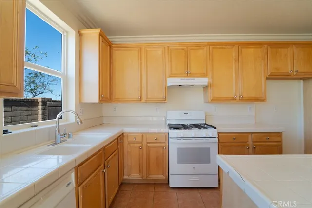 a kitchen with a sink stove and cabinets