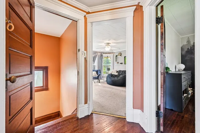 a dining room with furniture and a bookshelf