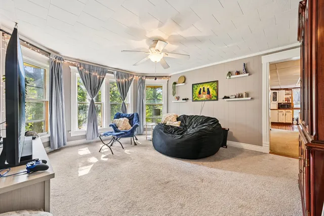 a kitchen with stainless steel appliances granite countertop a stove a sink and white cabinets with wooden floors