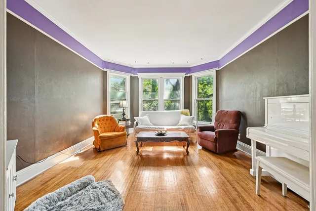 a view of a livingroom with furniture window and wooden floor