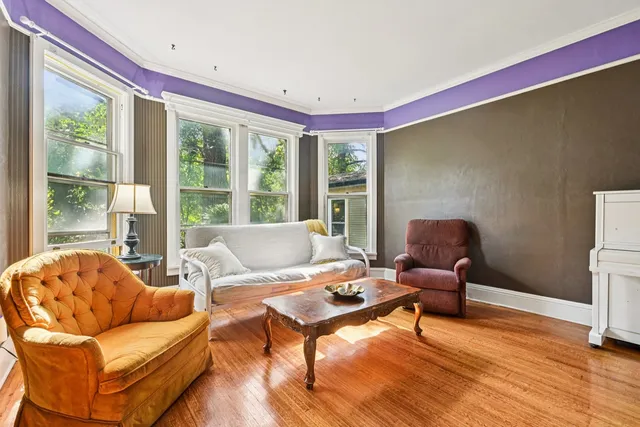 a view of a livingroom with furniture window and wooden floor