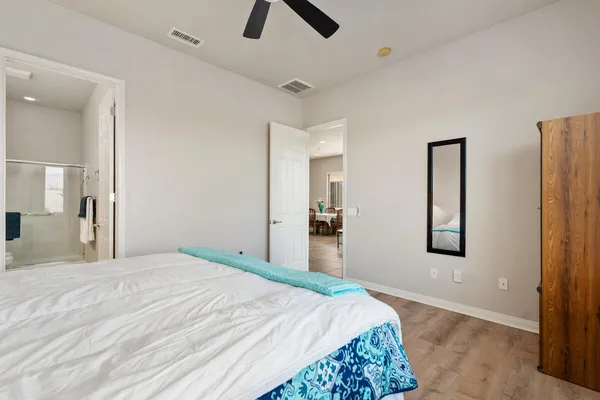 a bedroom with a bed and a chandelier
