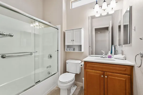 a bathroom with a sink vanity mirror and toilet