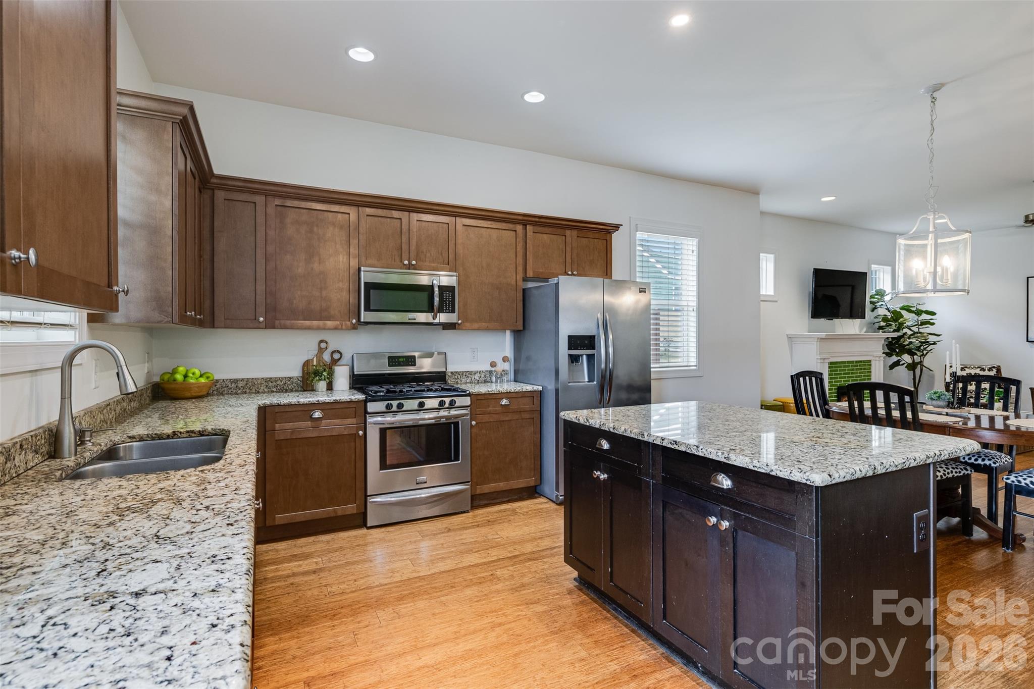 104 Meyers Ridge Road Cramerton, NC 28032 - Photo 6 of 36 a large kitchen with granite countertop a sink counter space appliances and cabinets