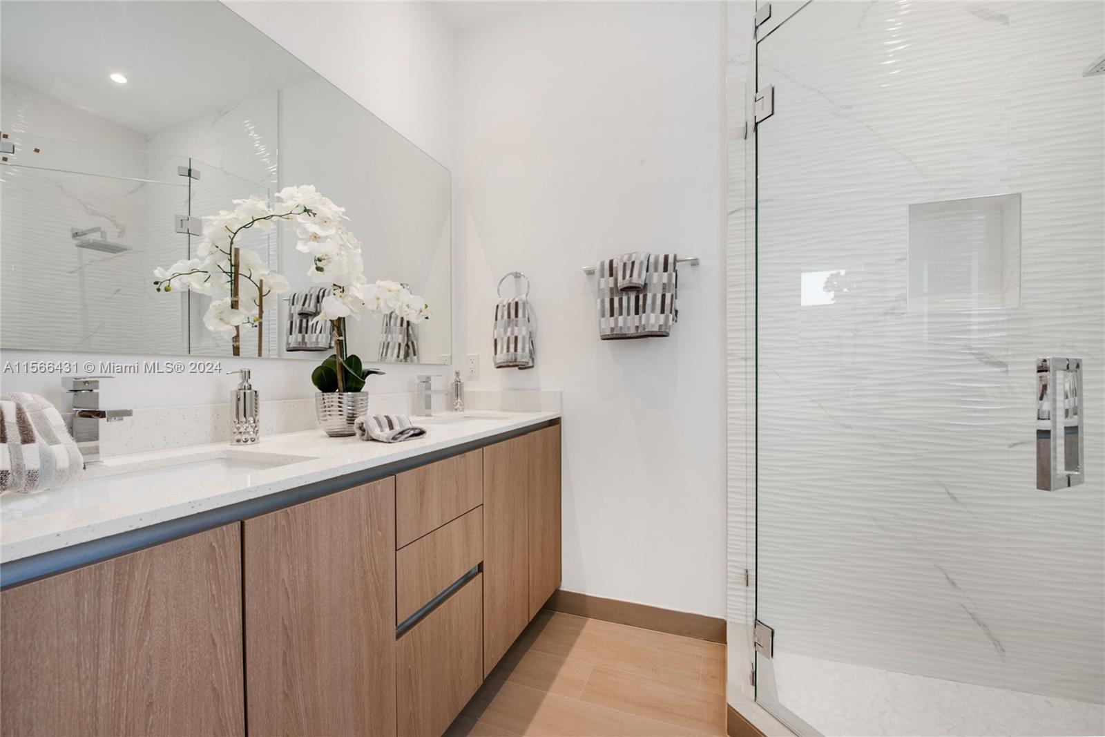 2872 Southwest 33rd Court Miami, FL 33133 - Photo 6 of 13 a bathroom with a double vanity sink a mirror and shower