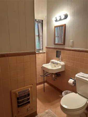 an empty room with a chandelier fan and windows