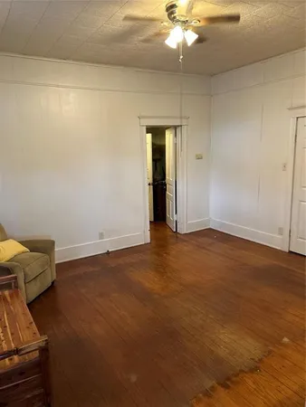 a view of an empty room and wooden floor