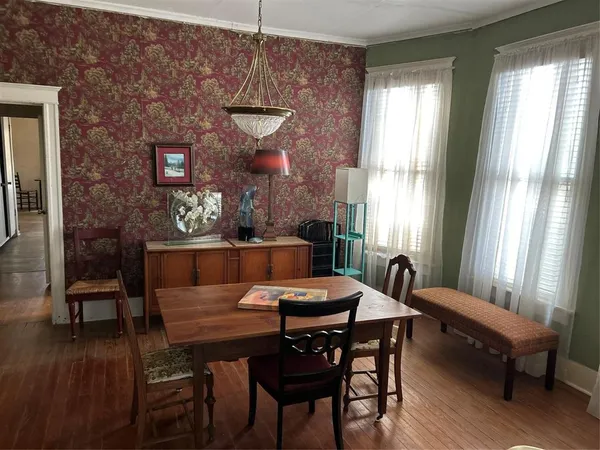 a view of a dining room with furniture and window