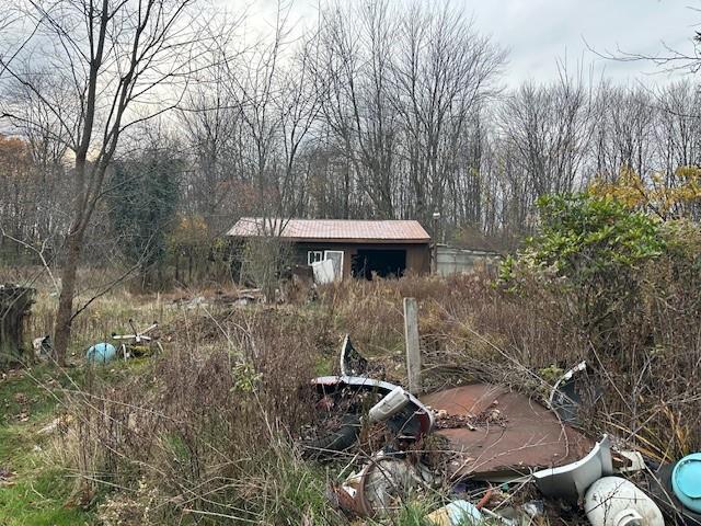 244 Hilltop Acres Road Slippery Rock, PA 16057 - Photo 5 of 12 a front view of a house with a yard and trees