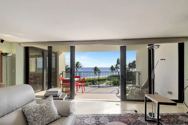 a view of a glass door with a view of a city from a balcony