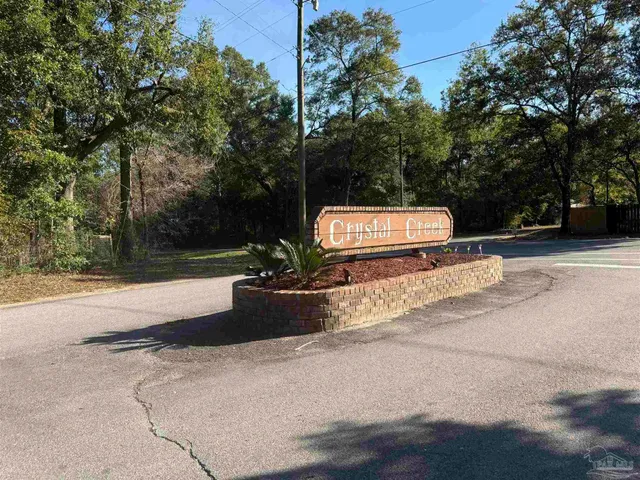 a view of a park with bench and trees
