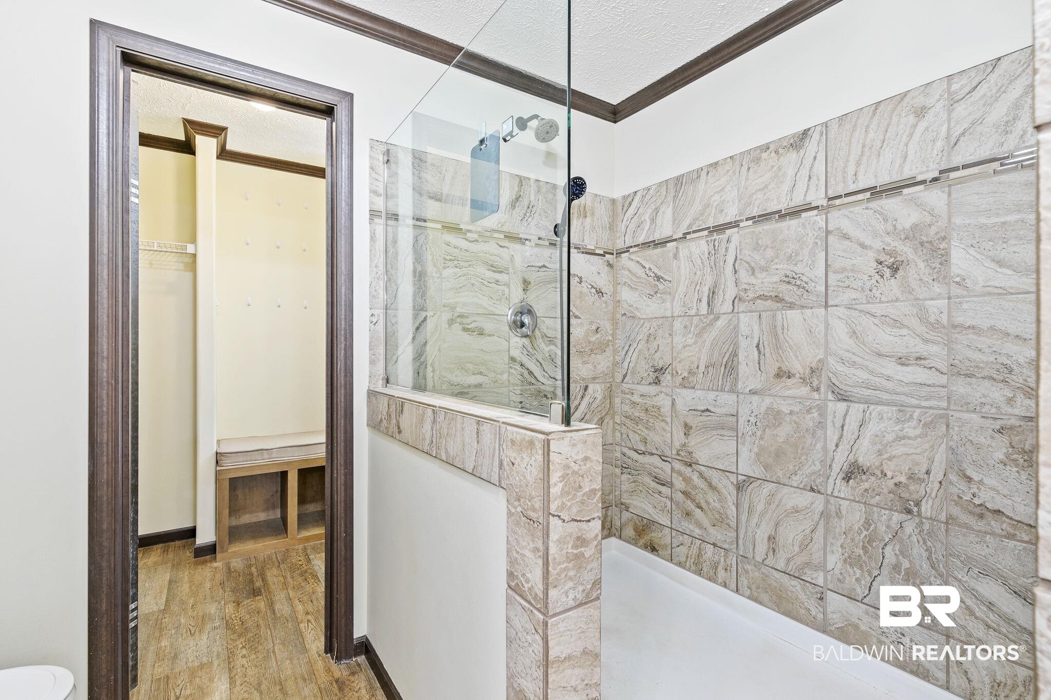 35641 County Road 39 Stapleton, AL 36578 - Photo 35 of 46 Bathroom featuring ornamental molding, hardwood / wood-style flooring, a tile shower, and a textured ceiling