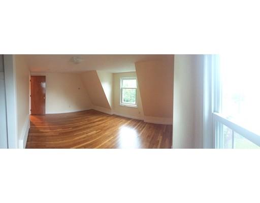 52 Meadowbrook Road Brookline, MA 02467 - Photo 12 of 20 a open living room with a couch and wooden floor